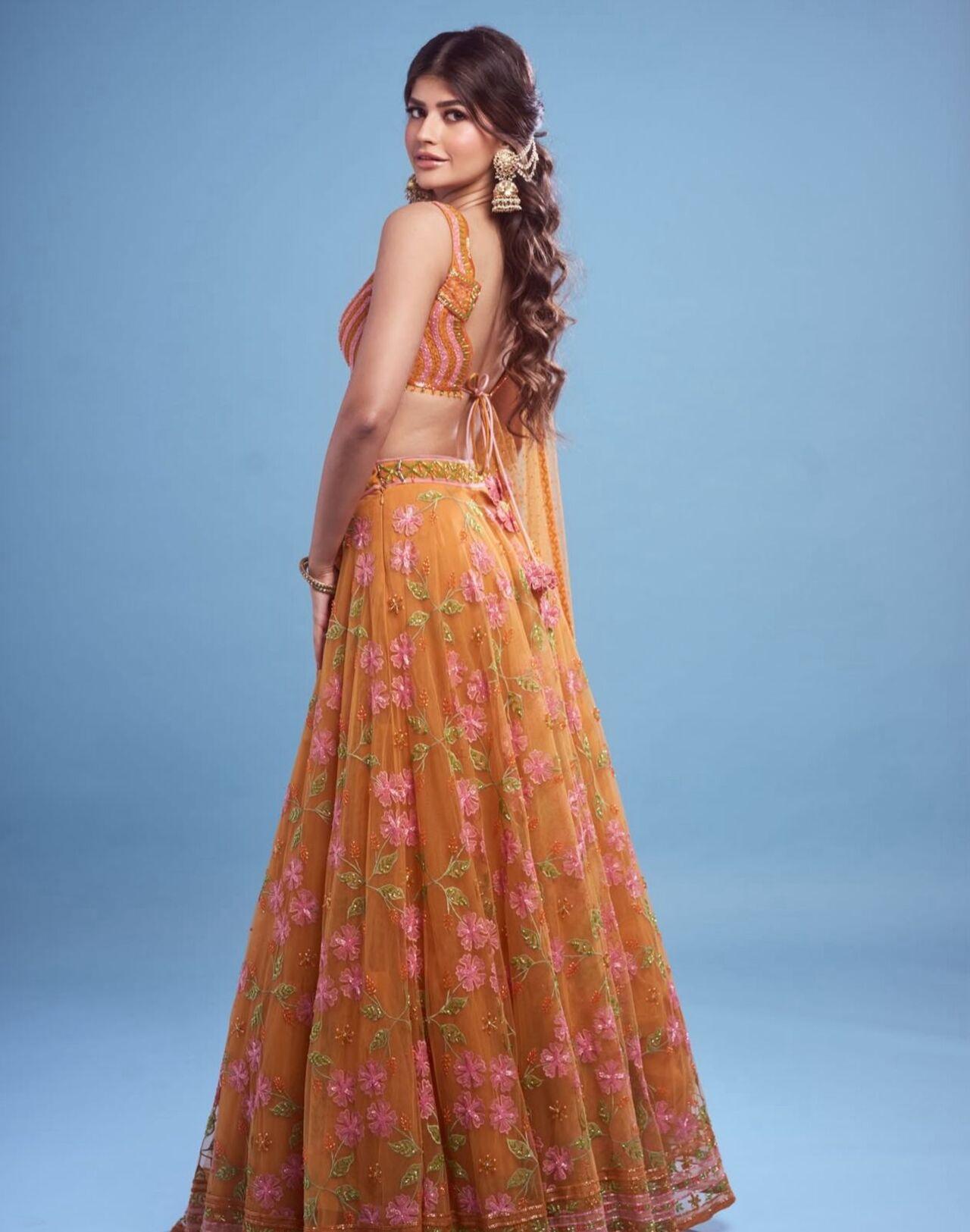 Anjini brings the festive spirit alive in a fiery orange lehenga that’s equal parts chic and traditional. The voluminous silhouette paired with minimal styling makes it a standout for garba nights.